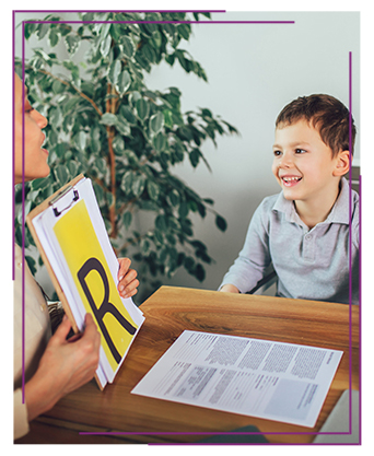 Young boy working with his teacher and letters