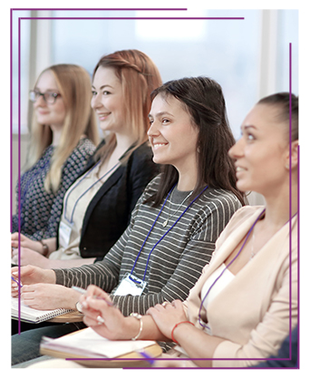 Group of happy teachers listening to a guest speaker